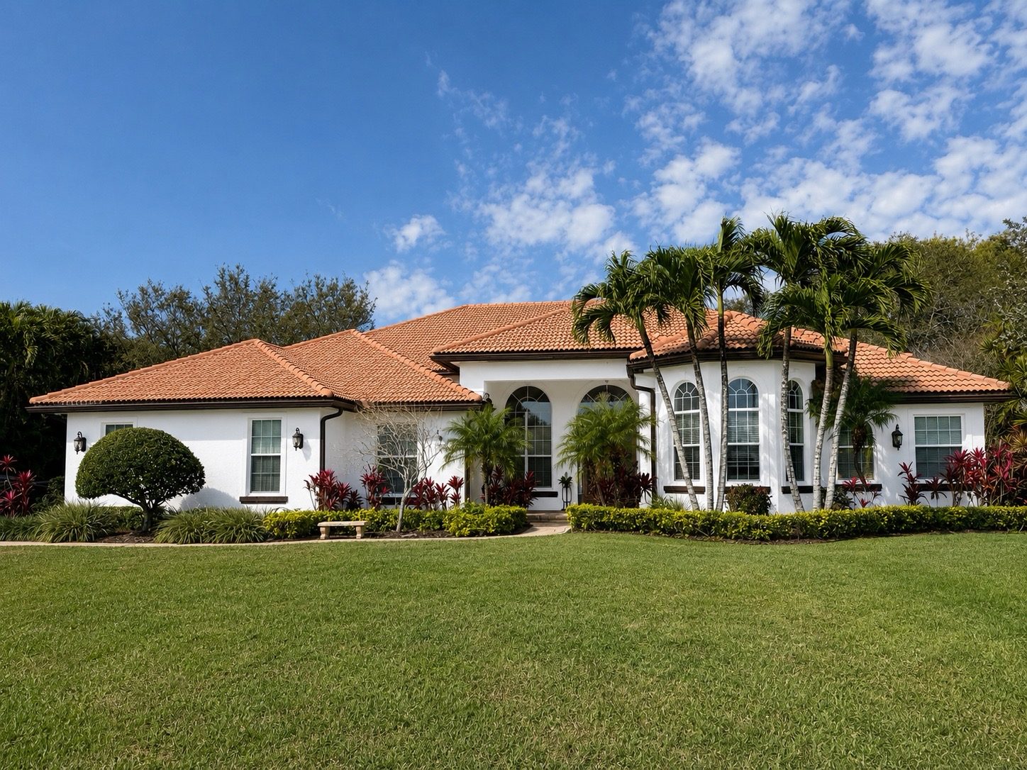 Freshly painted South Florida home with crisp white exterior and tile roof